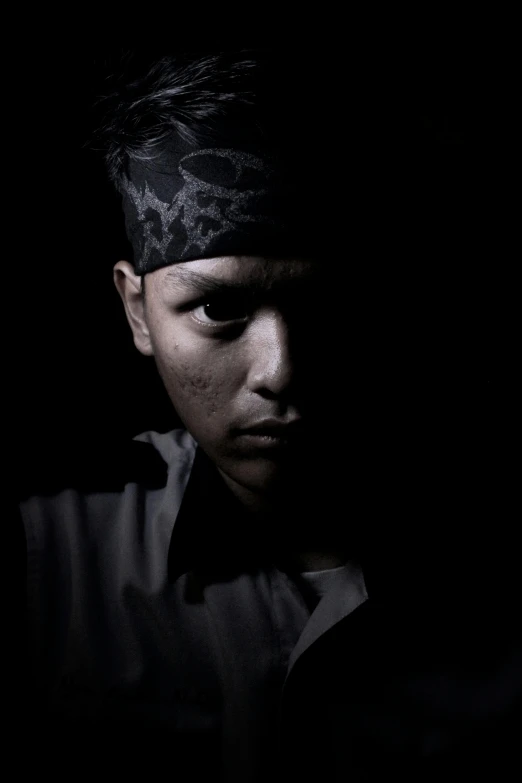 a man wearing a bandana in the dark, a character portrait, by Basuki Abdullah, flickr, portrait of a young pirate, teenage boy, scary shadow people, with grey skin