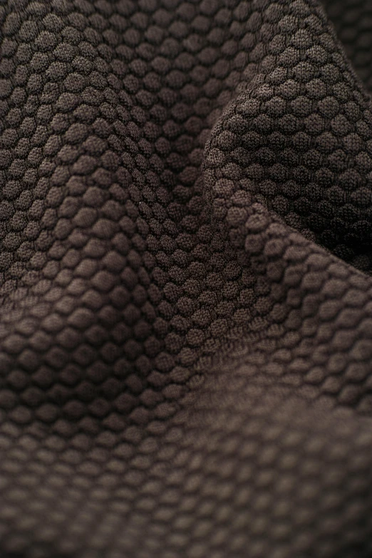 a close up of a piece of cloth, wearing nanotech honeycomb robe, dark brown, hdr fabric textures, product shot
