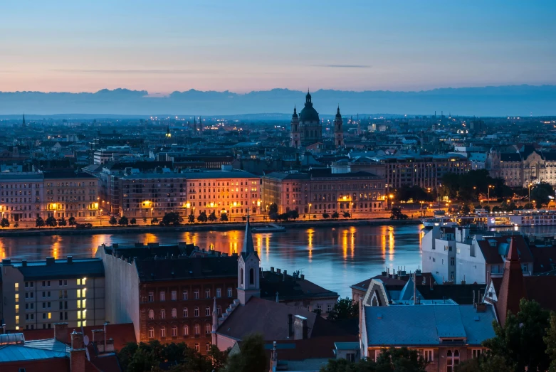 a view of a city from the top of a hill, by Adam Szentpétery, pexels contest winner, baroque, the river is full of lights, dusk setting, swedish urban landscape, from the grand budapest hotel