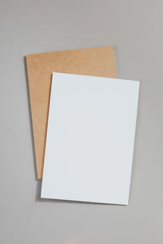 a piece of paper sitting on top of a table, a picture, cardboard, display item, whiteboards, brown