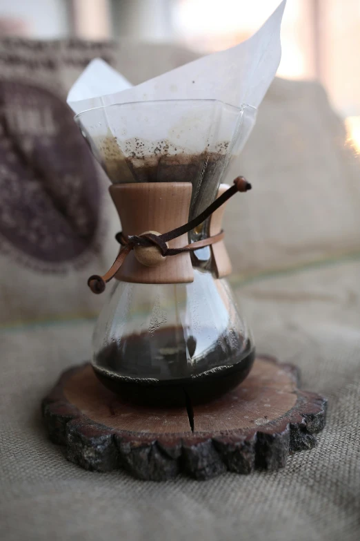 a close up of a coffee pot on a table, bark, medium, hour glass, cone shaped