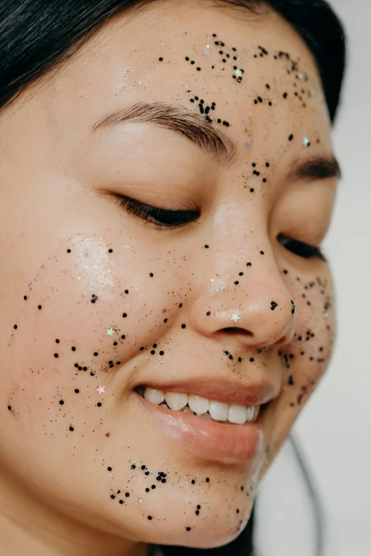 a woman with black spots on her face, trending on pexels, glittery, asian female, lush, face mask