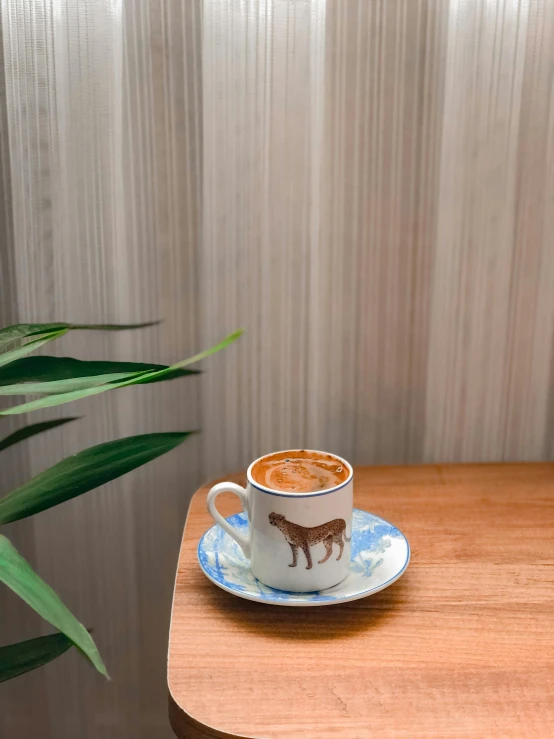 a cup of coffee sitting on top of a wooden table, jakarta, detailed product image, cafe for felted animals, thumbnail