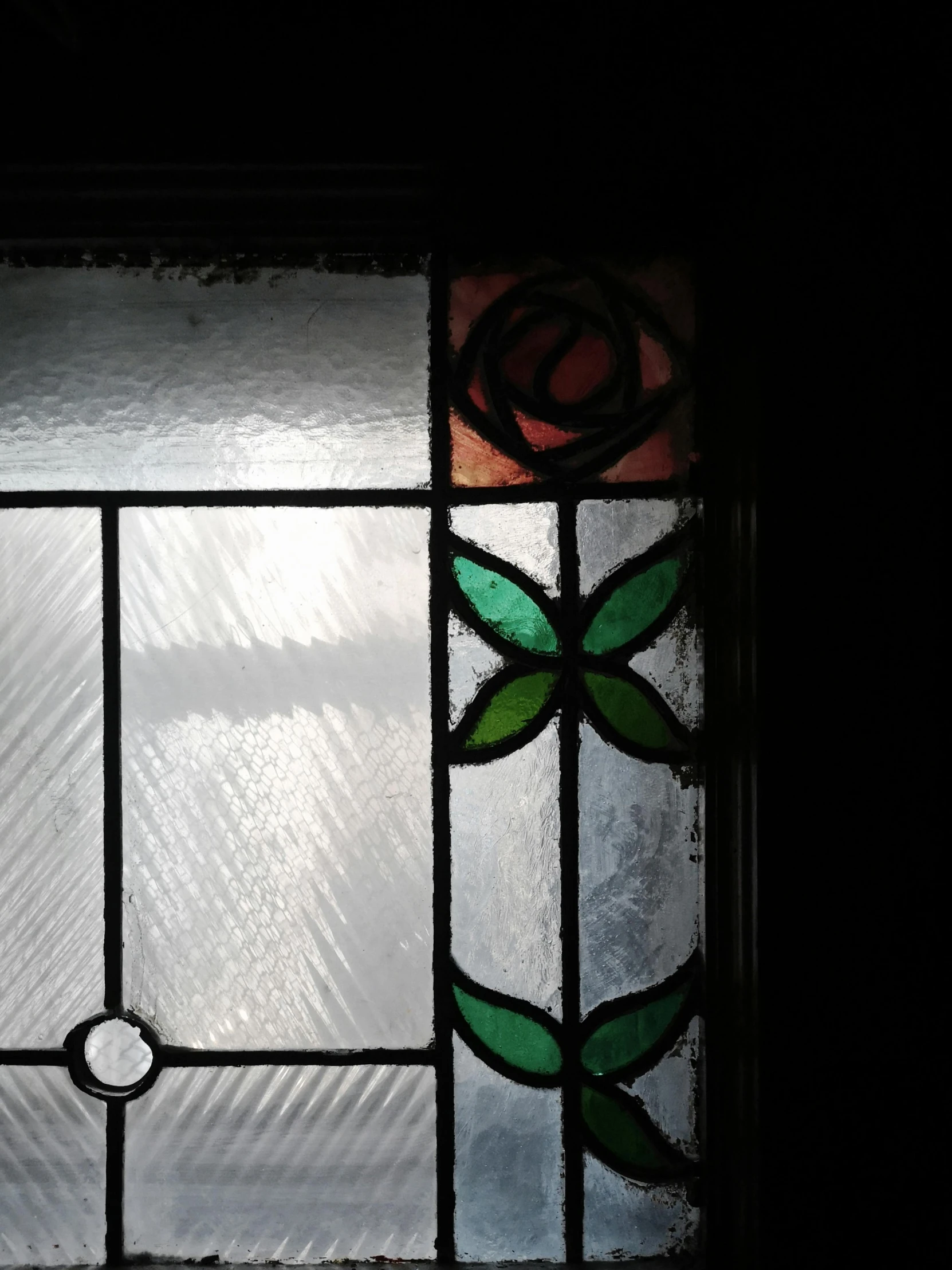 a stained glass window in a dark room, an album cover, inspired by Mihály Munkácsy, unsplash, arts and crafts movement, sparse detail, interior of a victorian house, high angle close up shot, doorway