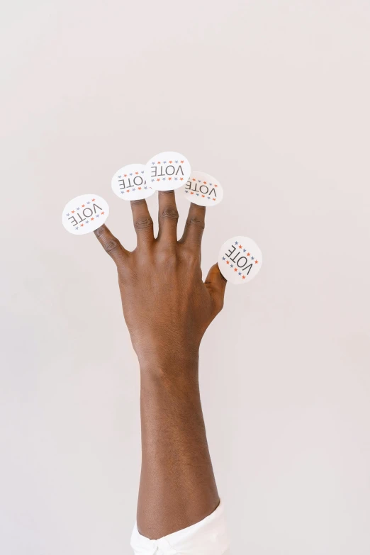 a close up of a person's hand with stickers on it, model pose, various sizes, hope, no text