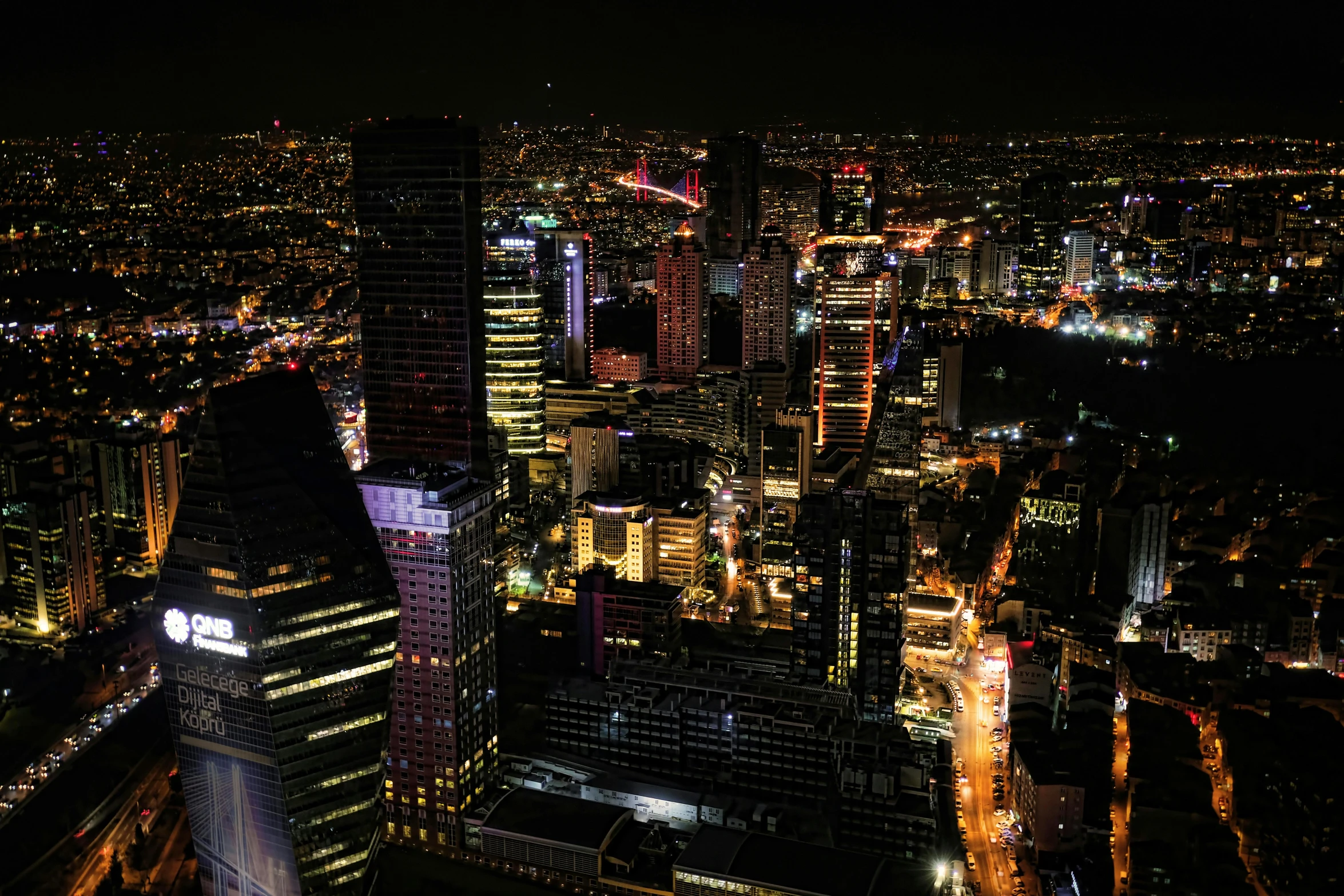 an aerial view of a city at night, by Adam Marczyński, pexels contest winner, happening, skyscrapers, view from the side, over - detailed, many details