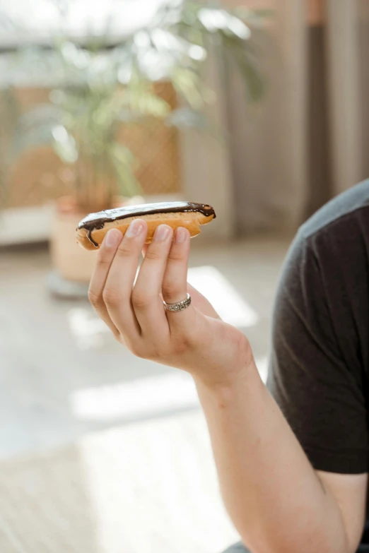 a close up of a person holding a cell phone, bread, with a sleek spoiler, shungite bangle, coffee stain