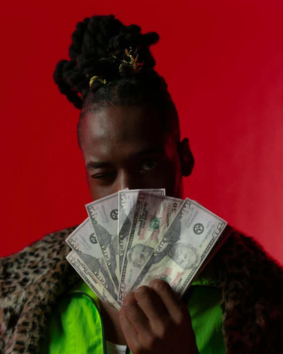 a woman holding a bunch of money in front of her face, an album cover, by Cosmo Alexander, trending on unsplash, maximalism, black teenage boy, 🐿🍸🍋, an epic non - binary model, loin cloth