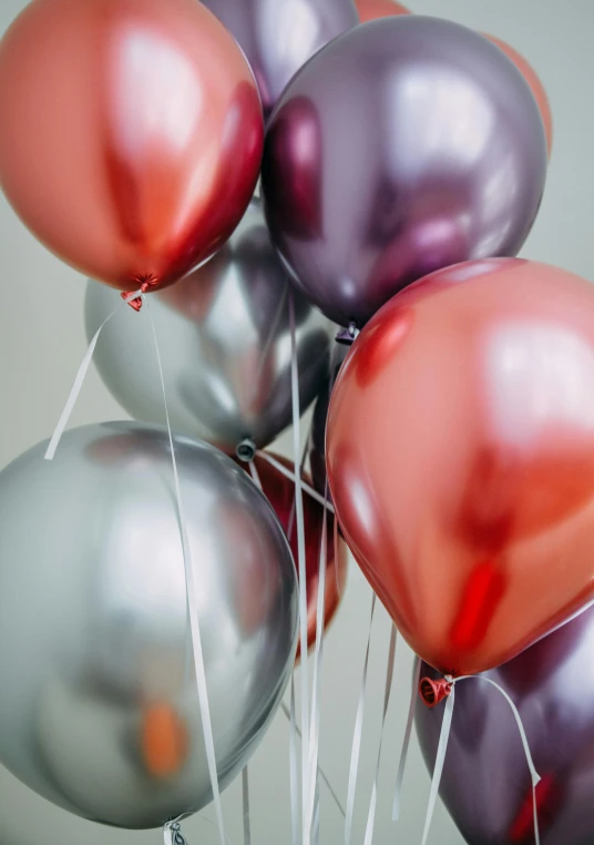 a bunch of balloons sitting on top of a table, payne's grey and venetian red, classic chrome, up close shot, uplifting