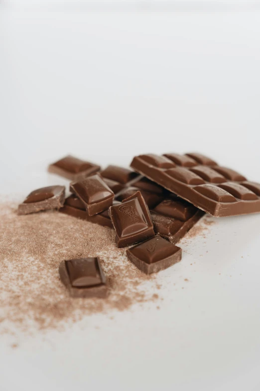 a pile of chocolate sitting on top of a table, pexels, light tan, crushed, thumbnail, 10k