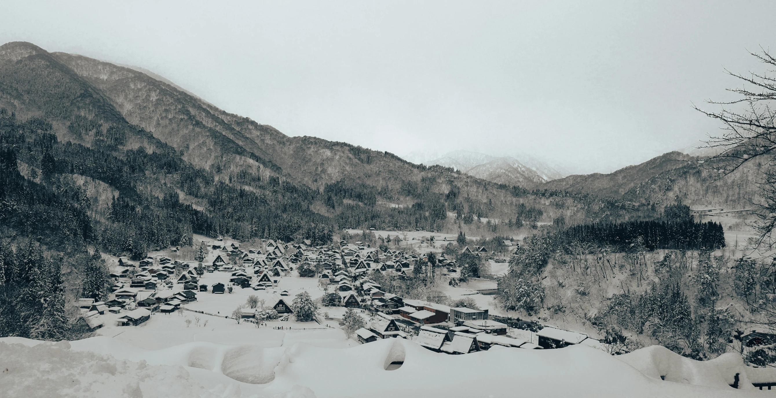 a black and white photo of a snow covered village, inspired by Maruyama Ōkyo, unsplash contest winner, grey skies, brown, lovely valley, background image