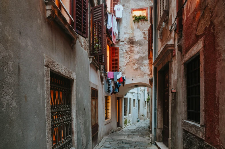 a narrow alley with clothes hanging out to dry, unsplash contest winner, renaissance, at dusk, split near the left, fine art print, overview