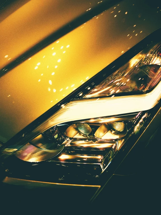 a close up of the headlights of a car, by Thomas Häfner, pexels contest winner, hyperrealism, gold theme, instagram story, profile image