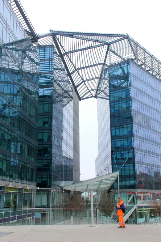 a man that is standing in front of a building, glass buildings, inside the building, two organic looking towers, canopies