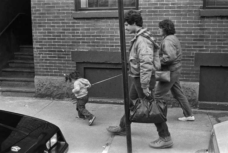 a group of people walking down a sidewalk, by Maurycy Gottlieb, flickr, father with child, pulling strings, from the 8 0 s, boston