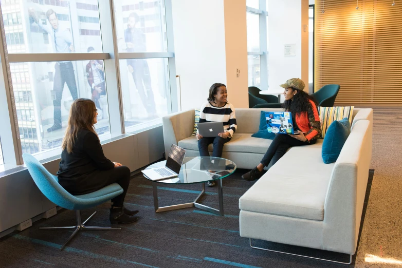 a couple of women sitting on top of a couch, by Harriet Zeitlin, unsplash, sitting in dean's office, irwin penn, three, calmly conversing 8k