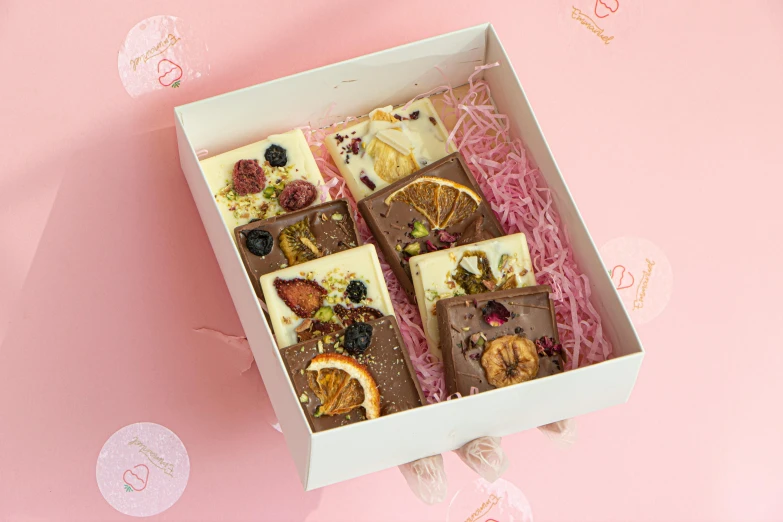 a close up of a box of food on a table, fully chocolate, 🎀 🍓 🧚, squares, 8 x