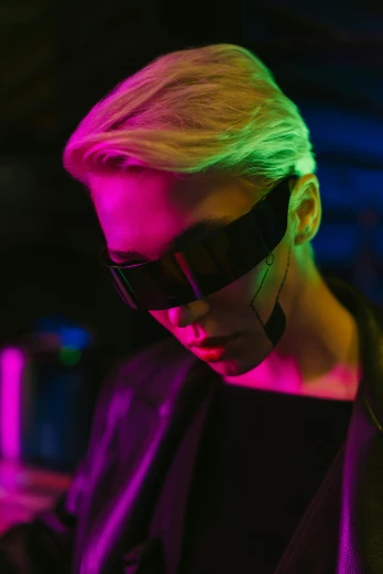 a close up of a person using a cell phone, cyberpunk art, trending on pexels, attractive androgynous humanoid, dark shades, in a nightclub, wearing futuristic clothing