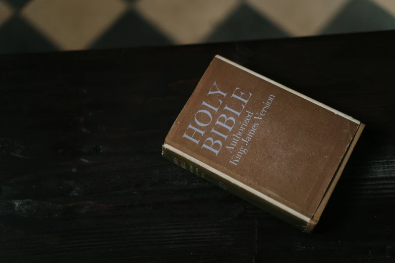 a book sitting on top of a wooden table, religión, brown, thumbnail, listing image