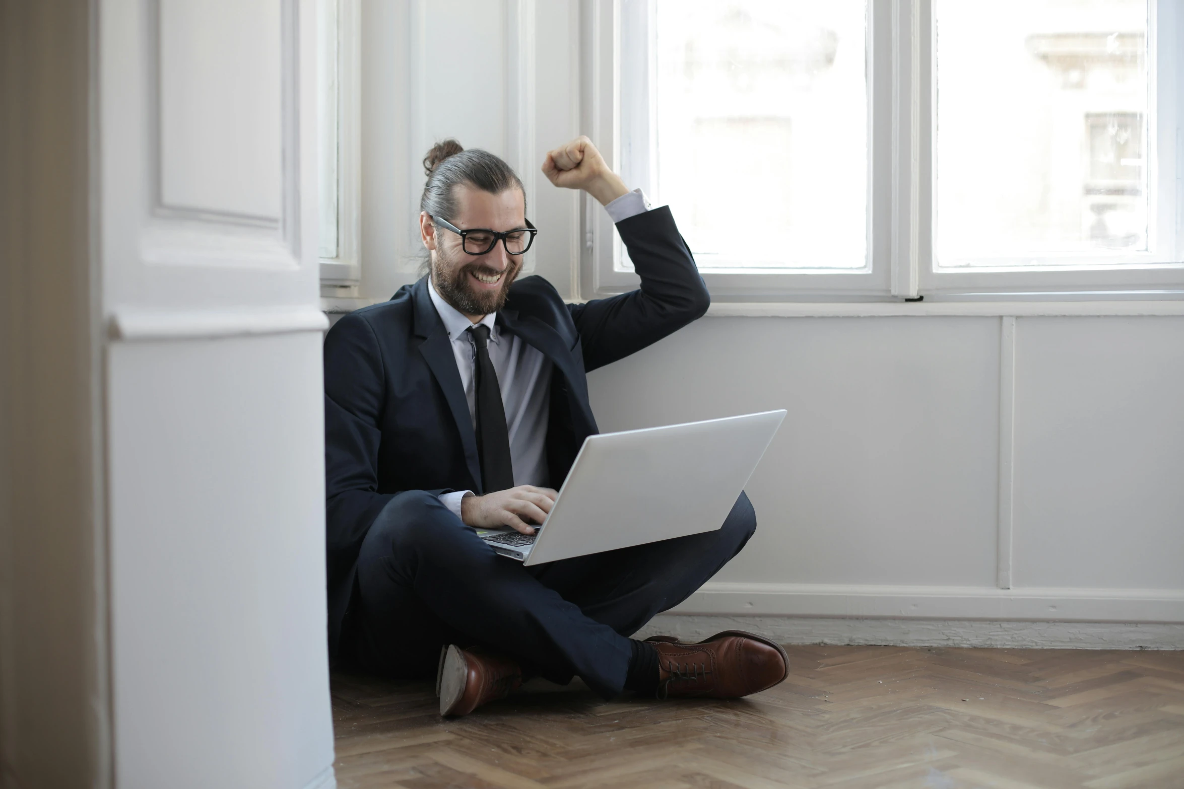 a man sitting on the floor using a laptop, inspired by Edi Rama, pexels contest winner, triumphant pose, lachlan bailey, lawyer, slight nerdy smile