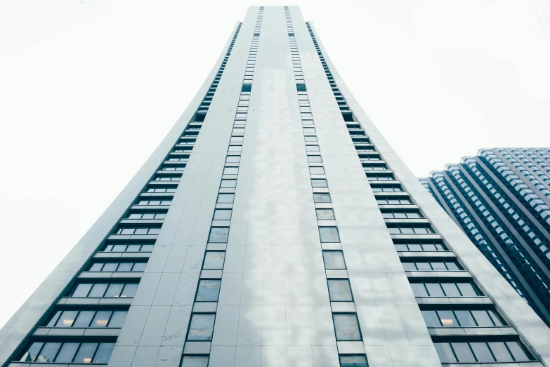 a very tall building with lots of windows, unsplash, white pale concrete city, 2 0 0 0's photo, high resolution photograph, ground level view