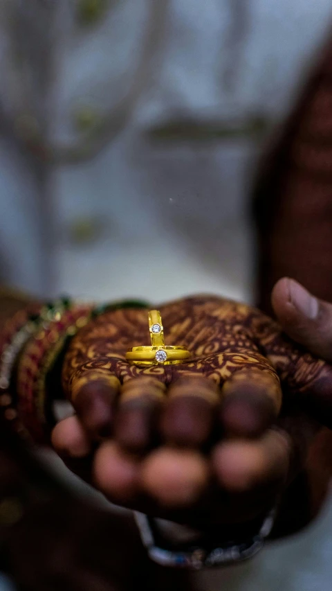 a close up of a person holding a ring, hurufiyya, thumbnail, india, digital image, wedding