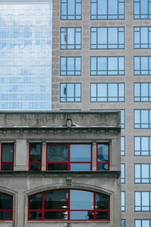 a red fire hydrant sitting in front of a tall building, inspired by Donald Judd, trending on unsplash, cyan shutters on windows, stone and glass, seen from a distance, pittsburgh