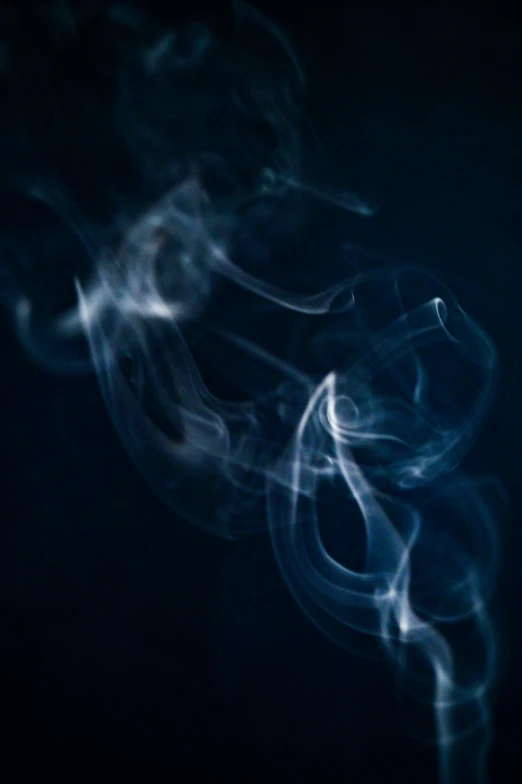 a close up of smoke on a black background, by Daniel Seghers, unsplash, blue haze, spiraling, praying with tobacco, ignant