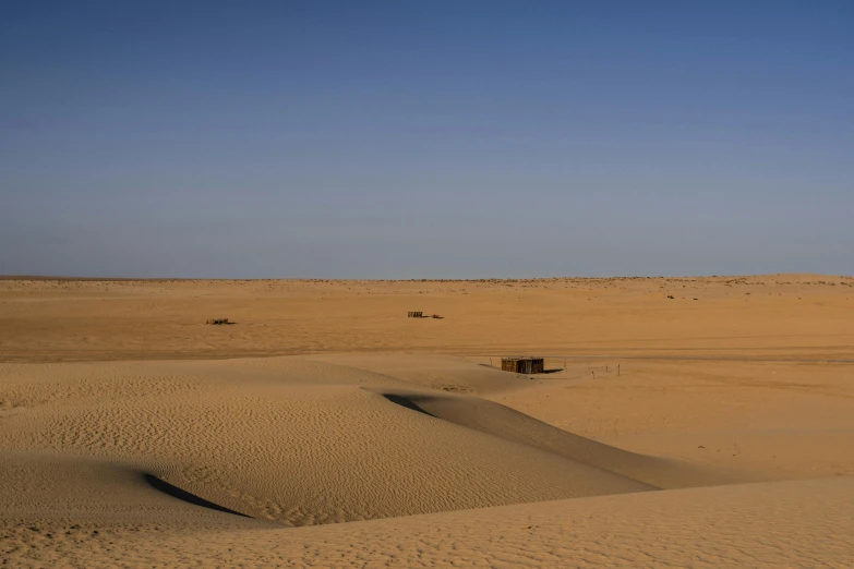 a man flying a kite in the middle of a desert, les nabis, bunkers, half submerged in heavy sand, seen from afar, slide show