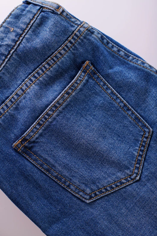 a pair of jeans sitting on top of a table, a high angle shot, detailed product image, zoomed out shot, waist - shot