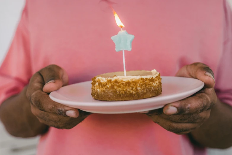 a close up of a person holding a plate with a cake on it, trending on unsplash, figuration libre, candle volumetric, michellin star, birthday, background image