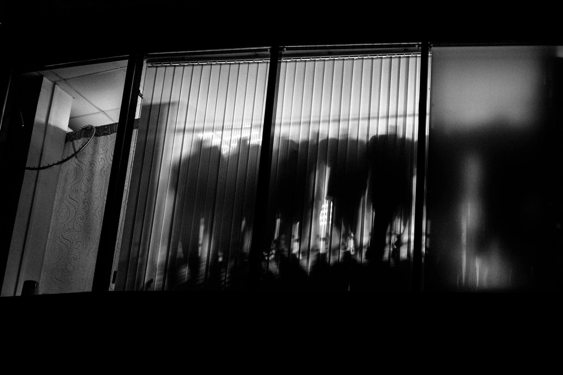 a black and white photo of the outside of a building, by Tobias Stimmer, people's silhouettes close up, closed limbo room, uploaded, waiting to strike