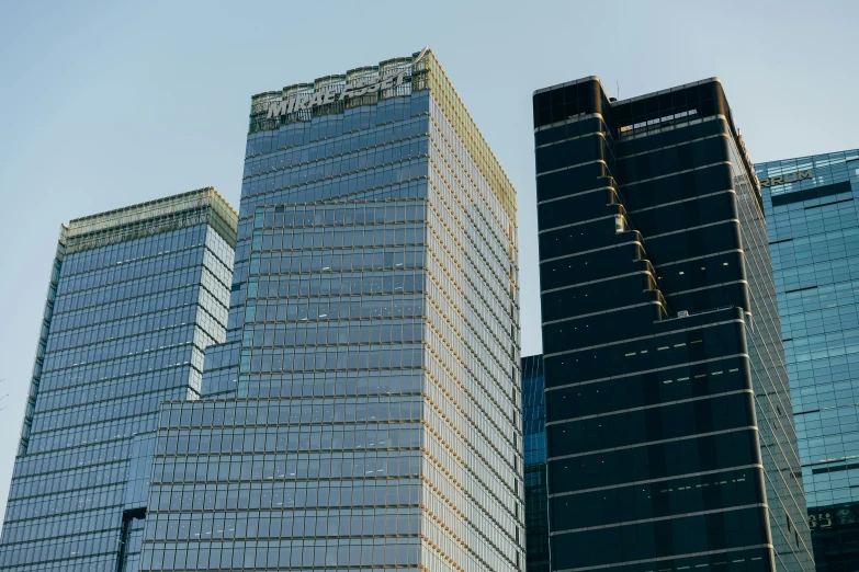 a couple of tall buildings sitting next to each other, unsplash, modernism, beijing, multiple stories, masami suda, exterior shot