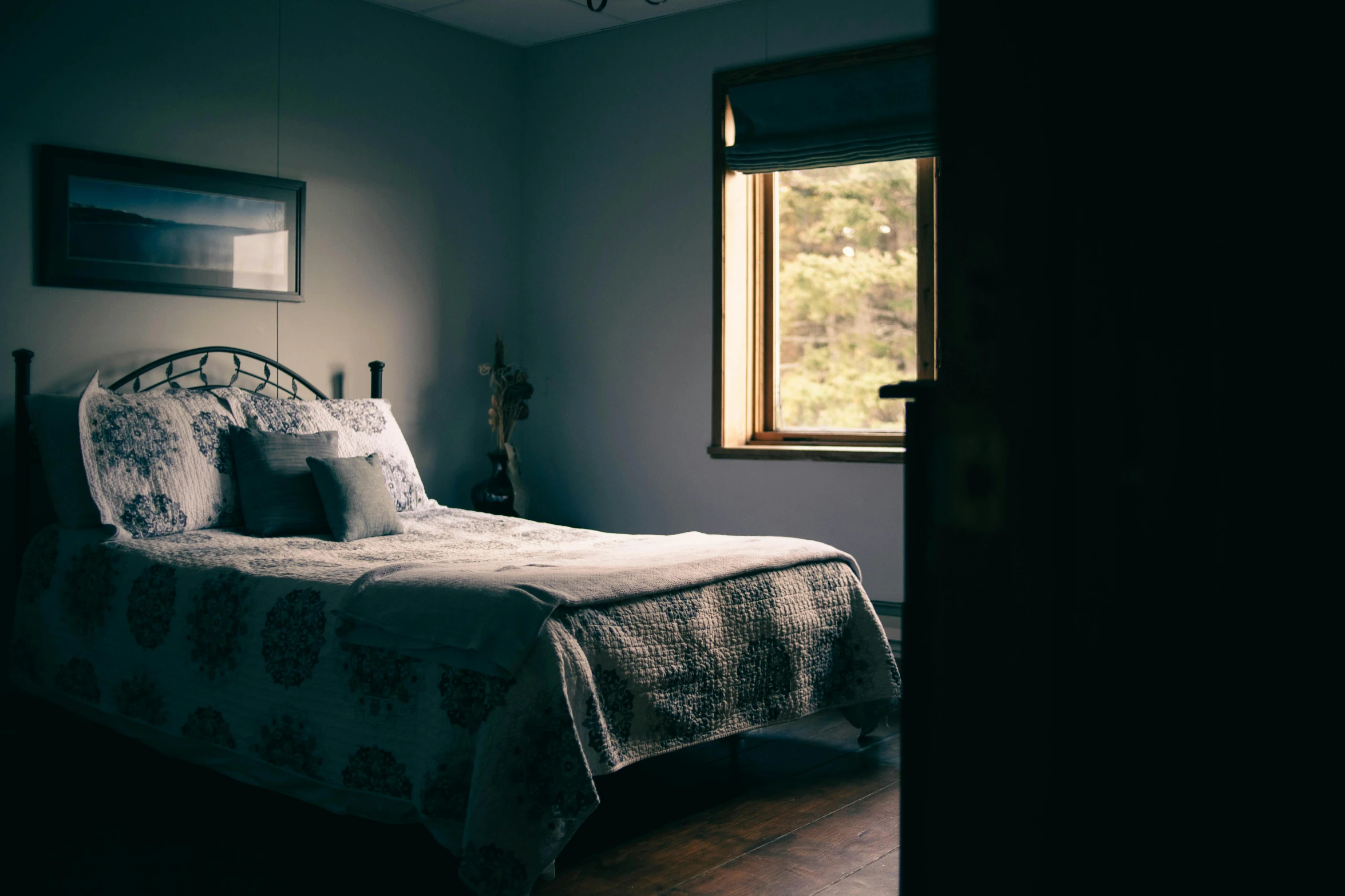 a bed sitting in a bedroom next to a window, unsplash, australian tonalism, cottagecore, blue room, grey, silhouetted