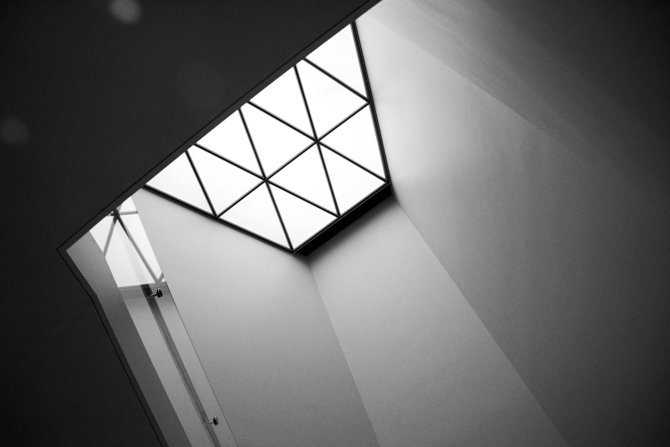 a black and white photo of a window in a building, light and space, skylight open ceiling, sharp geometrical squares, fluorescent ceiling lights, ( geometric )