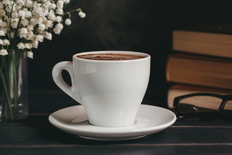 a cup of coffee sitting on top of a saucer, inspired by George Jamesone, pexels contest winner, hot cocoa drink, moody setting, white steam on the side, three - quarter view