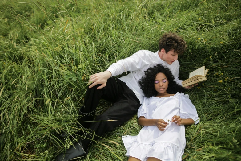 a man and a woman laying in the grass, pexels, renaissance, white and black clothing, sza, nico wearing a white dress, reading