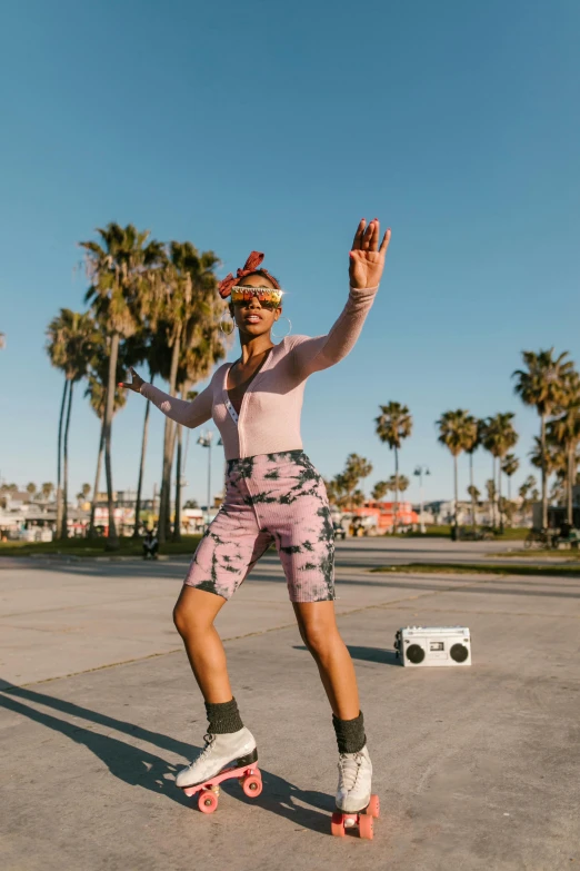 a man riding a skateboard down a street next to palm trees, by Julia Pishtar, happening, she is dancing, ashteroth, a person at a music festival, profile image