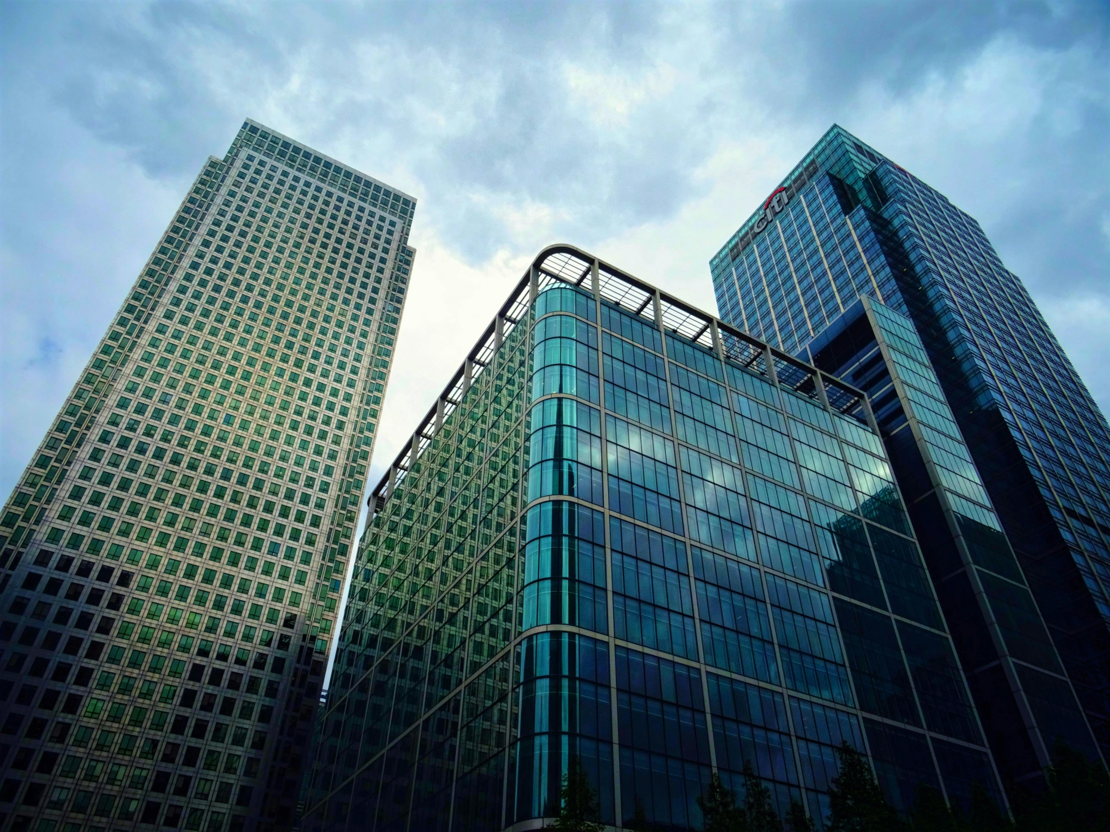 some very tall buildings in a big city, unsplash, hyperrealism, canary wharf, taken in the late 2000s, square, a large