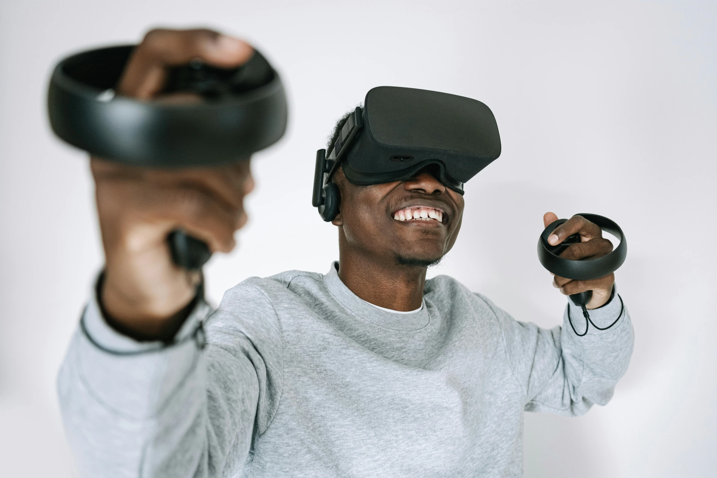 a man holding a video game controller in his hand, a 3D render, by Carey Morris, pexels contest winner, afrofuturism, using a vr headset, everyone having fun, portrait of linus torvalds, twins playing video games