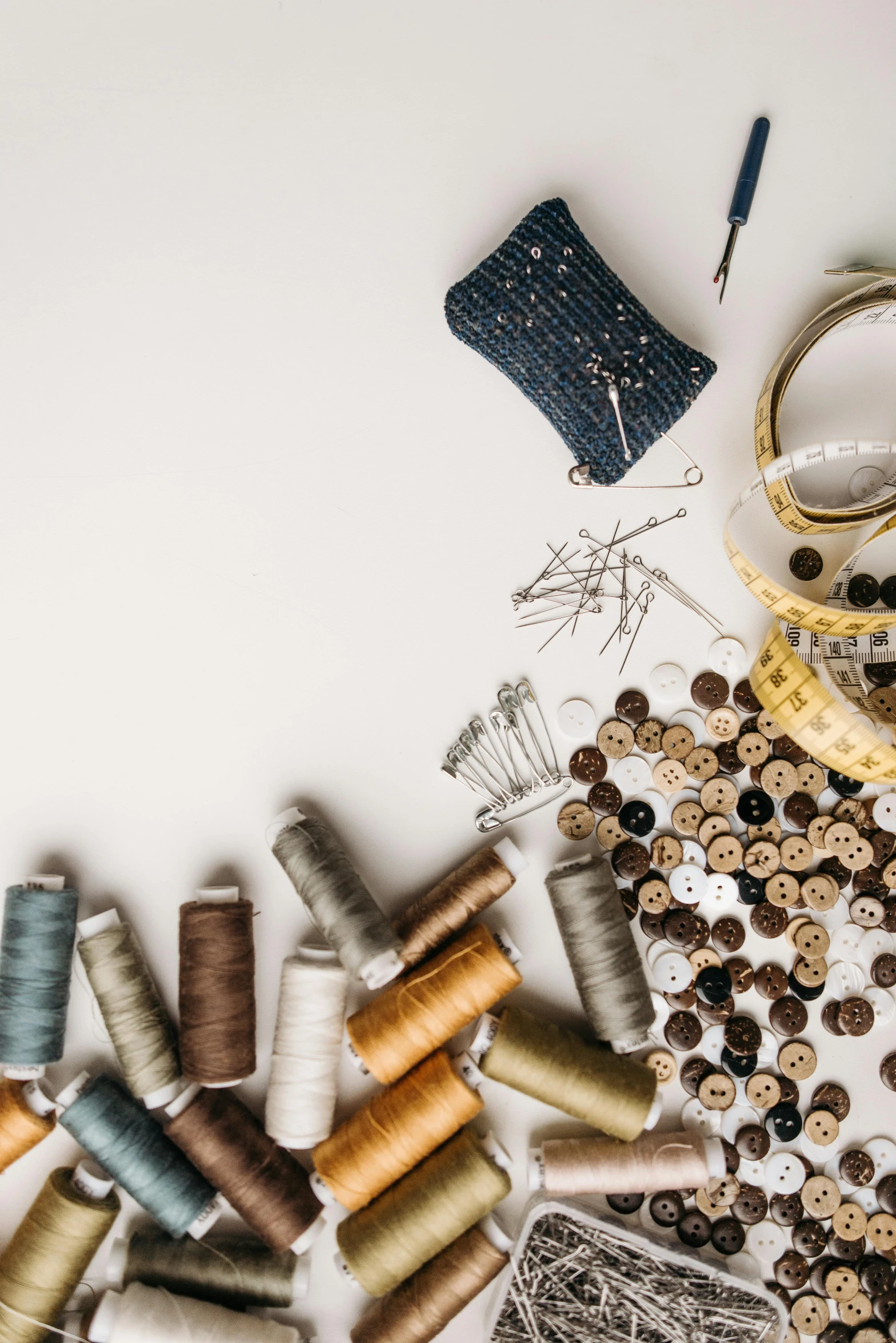 a table topped with spools of thread and a pair of scissors, trending on pexels, intricate clothing, thumbnail, studio shot, brown