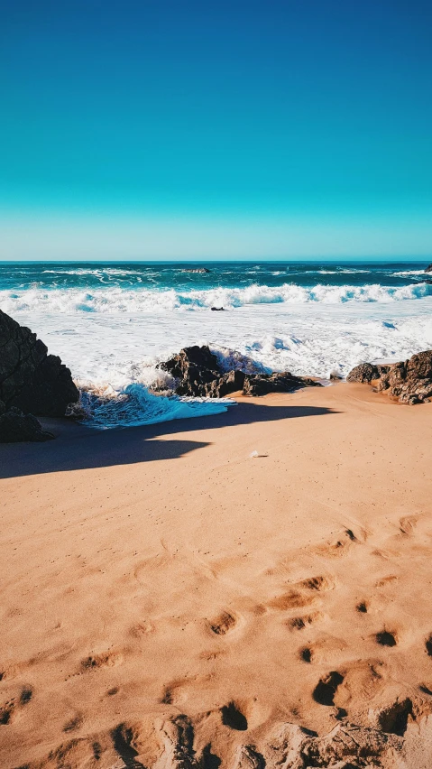 a surfboard sitting on top of a sandy beach, pexels contest winner, baroque, waves crashing at rocks, thumbnail, portugal, multiple stories