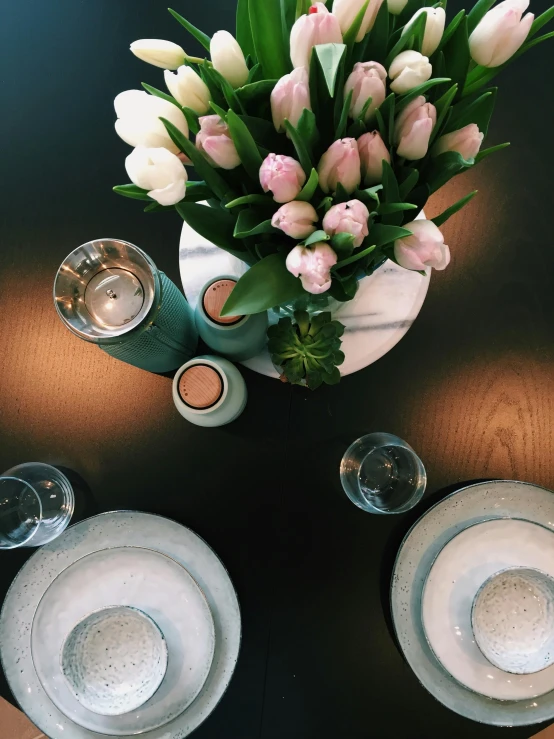 a vase of flowers sitting on top of a table, inspired by Constantin Hansen, happening, dining table, tulip, pink accents, 10k