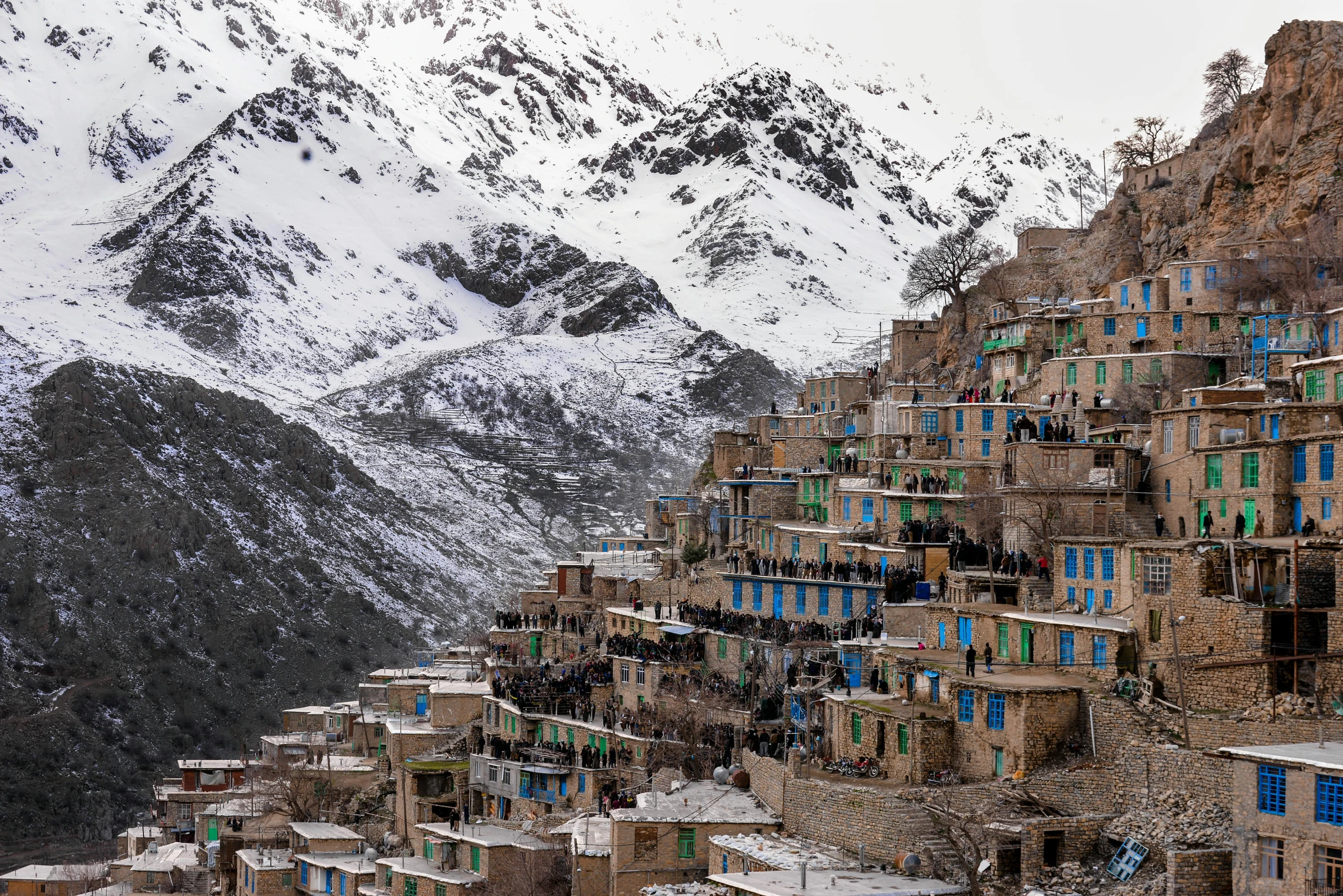 a village on the side of a mountain covered in snow, by Taravat Jalali Farahani, trending on unsplash, visual art, color image, art print, andes