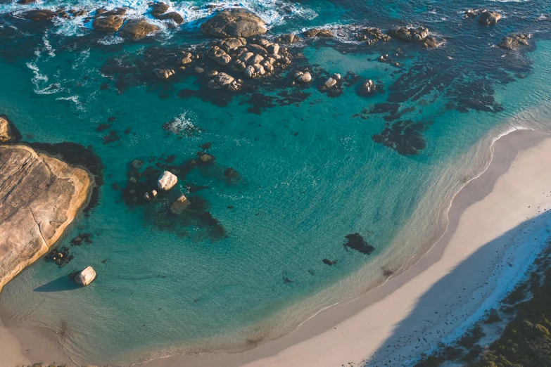 a large body of water next to a sandy beach, by Lee Loughridge, unsplash contest winner, helicopter view, sparkling cove, wellington, thumbnail