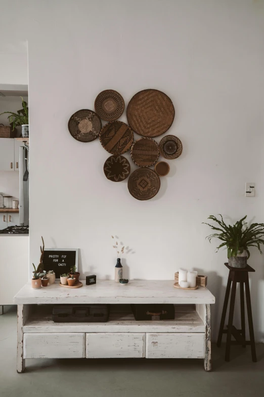 a living room filled with furniture and a plant, pexels contest winner, ecological art, white background wall, pan and plates, brown:-2, small kitchen