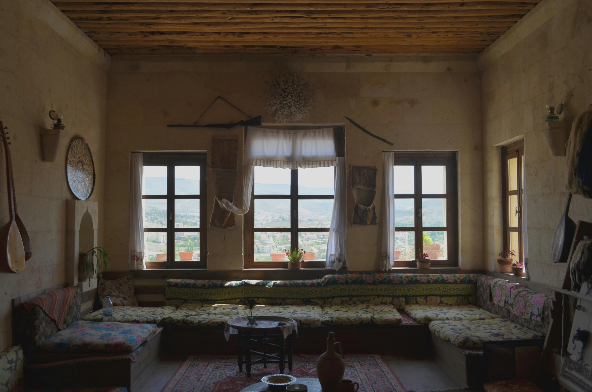 a living room filled with furniture and lots of windows, an album cover, inspired by Riad Beyrouti, pexels contest winner, sitting in rural living room, turkey, museum photo, the panorama