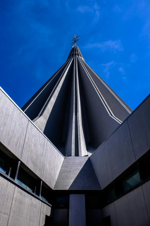 a tall building with a cross on top of it, an abstract sculpture, inspired by Tadao Ando, unsplash, brutalism, pointy conical hat, reykjavik junior college, elevation view, extremely wide angle