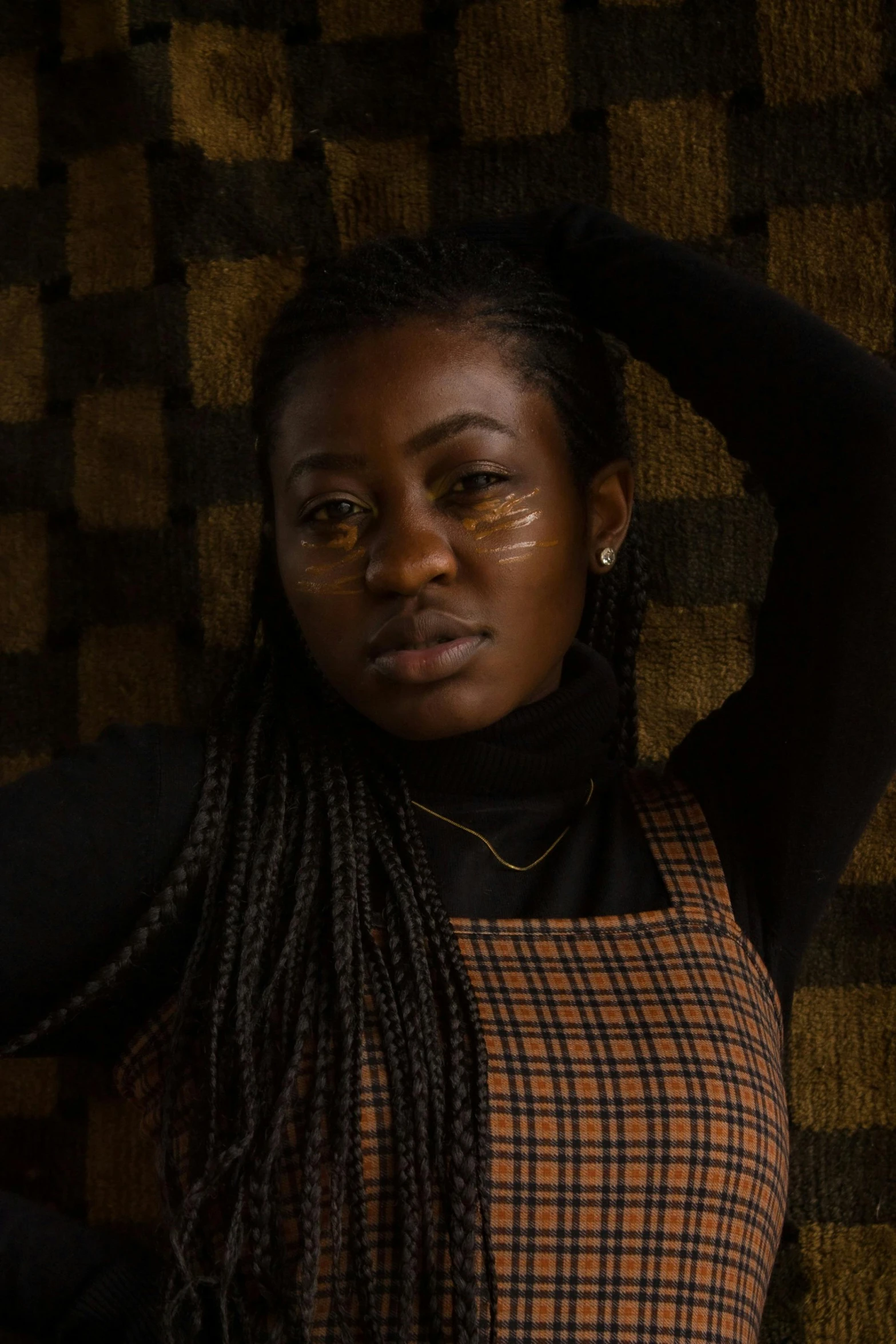 a woman with dreadlocks posing for a picture, an album cover, inspired by Chinwe Chukwuogo-Roy, trending on unsplash, muted brown, concerned expression, panel of black, yoruba body paint