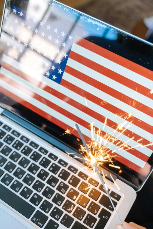 a person holding a laptop with an american flag on the screen, shutterstock, digital art, pyrotechnics, celebration, 2 5 6 x 2 5 6 pixels, iconic shot